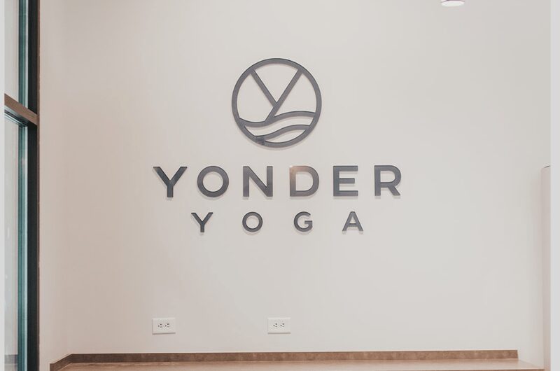 Yonder Yoga studio logo on wall.