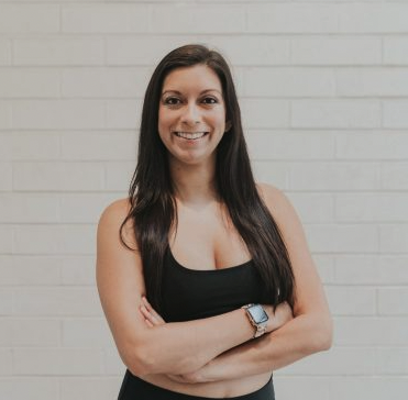 A woman standing with her arms crossed.