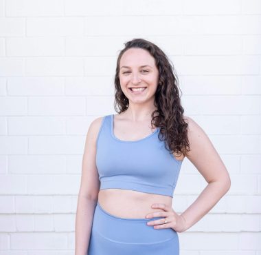 Smiling woman in blue athletic wear.