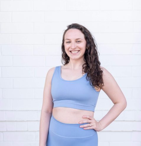 Smiling woman in blue athletic wear.