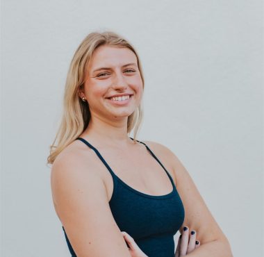 A woman standing with her arms crossed.