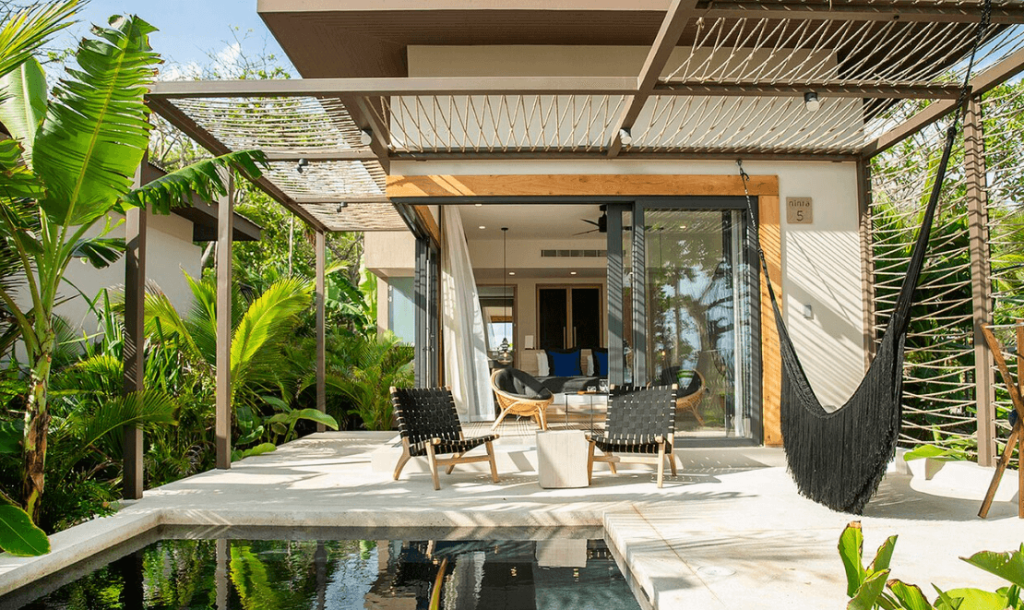 Modern patio with hammock and small pool.