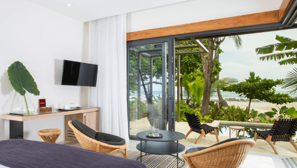 Beachfront room with patio and ocean view.