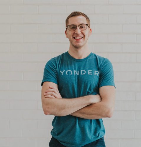 Smiling man in blue Yonder t-shirt.