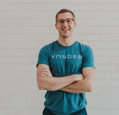 Smiling person in blue Yonder shirt.