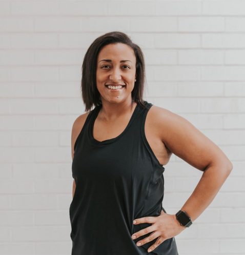 Smiling woman in black tank top.