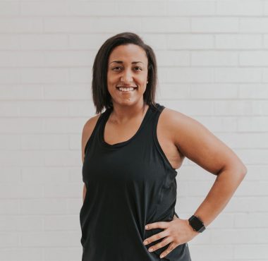 Person smiling in black tank top.