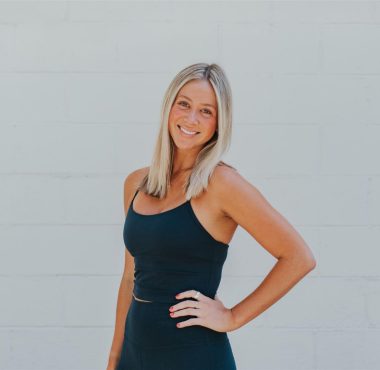 Smiling woman in black tank top.